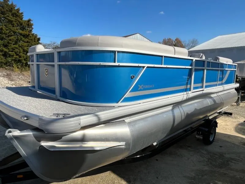 Slide: The Image of 2024 Sweetwater 2286SBCX pontoon boat with blue exterior and silver pontoons. - 3