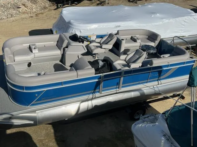 Slide: The Image of 2024 Sweetwater 2286SBCX pontoon boat with blue exterior and spacious seating. - 4
