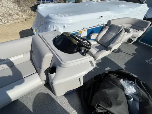 Slide: The Image of 2024 Sweetwater 2286SBCX pontoon boat interior with helm and seating. - 6