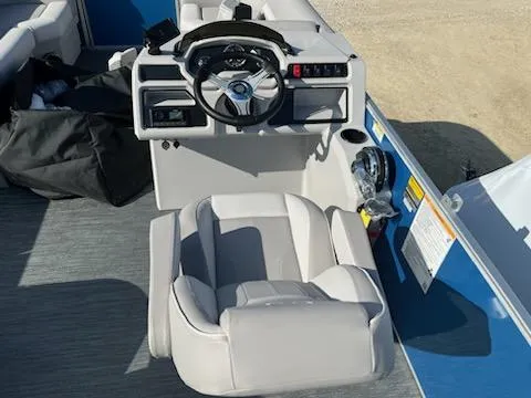 Slide: The Image of 2024 Sweetwater 2286SBCX boat helm with steering wheel and captain's chair. - 8