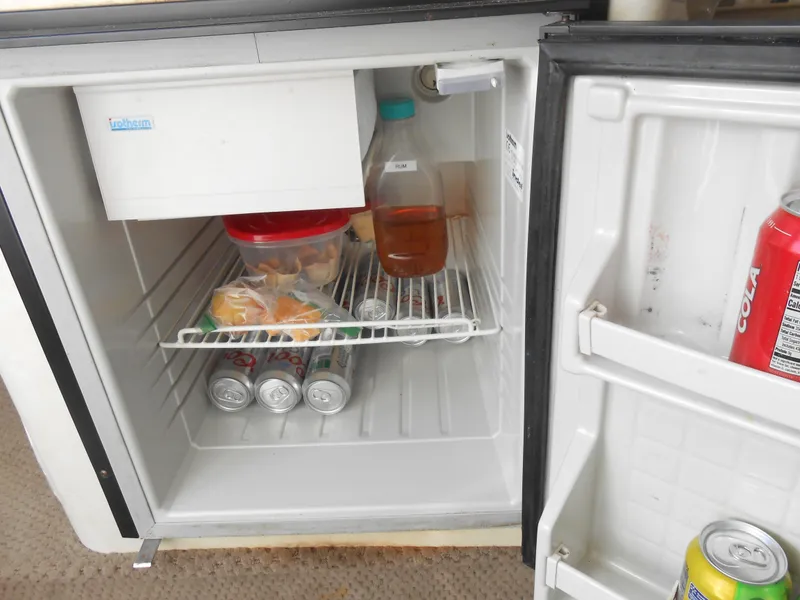 Slide: The Image of Open mini fridge on a 2003 Glastron GS249 boat with drinks and food. - 10