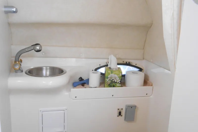 Slide: The Image of 2003 Glastron GS249 boat bathroom with sink and mirror. - 14