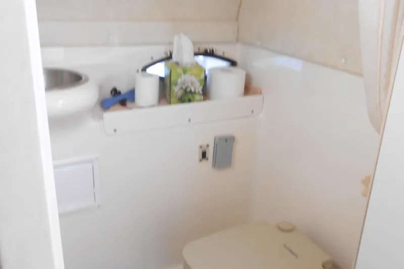 Slide: The Image of Compact bathroom in a 2003 Glastron GS249 boat with sink and toilet. - 15