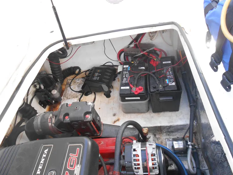 Slide: The Image of Engine compartment of a 2003 Glastron GS249 boat with batteries and wiring. - 18