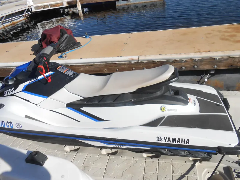 Slide: The Image of White Yamaha jet ski docked near water. - 19
