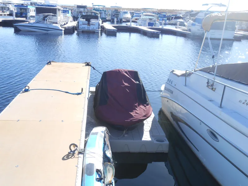 Slide: The Image of 2003 Glastron GS249 boat docked at marina with covered jet ski. - 20