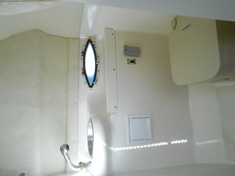 Slide: The Image of Interior of 2003 Glastron GS249 boat with porthole and fixtures. - 23