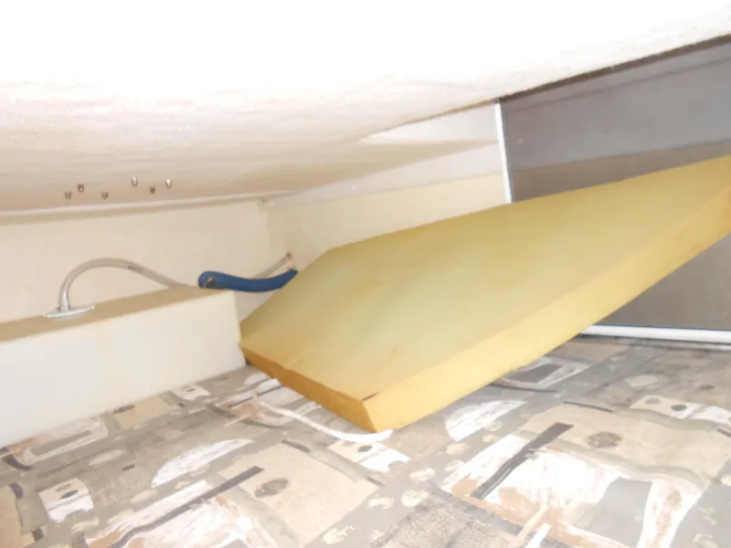 Slide: The Image of Interior of 2003 Glastron GS249 boat with storage compartment and cushion. - 24