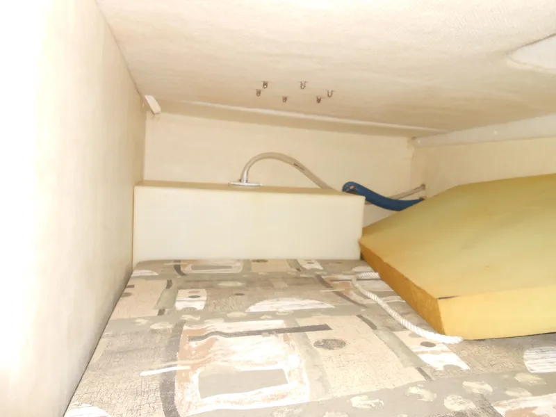 Slide: The Image of Interior cabin of 2003 Glastron GS249 boat with mattress and storage space. - 26