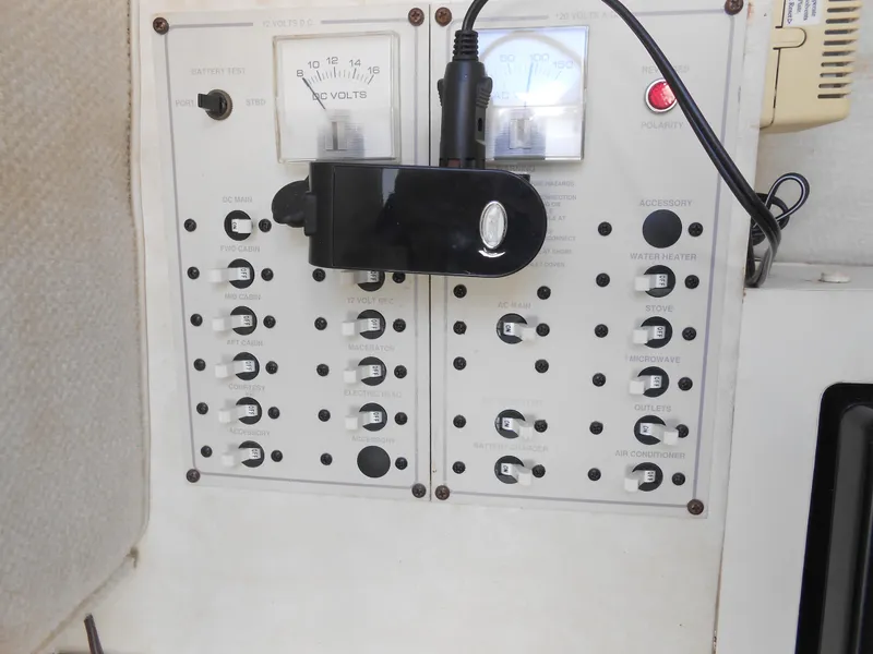 Slide: The Image of Control panel of a 2003 Glastron GS249 boat with switches and voltmeter. - 29