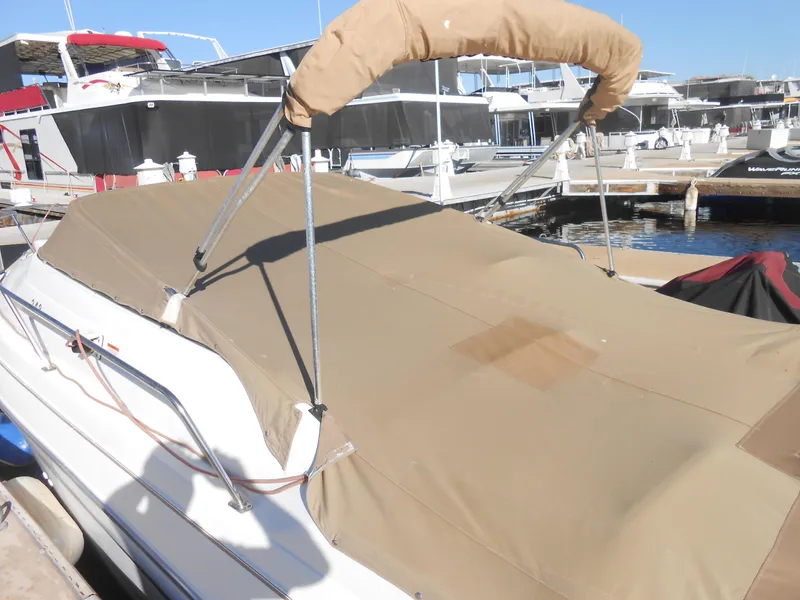 Slide: The Image of 2003 Glastron GS249 boat with tan cover docked at marina. - 4