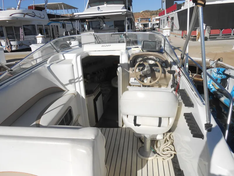 Slide: The Image of 2003 Glastron GS249 boat interior with steering wheel and cabin view. - 6