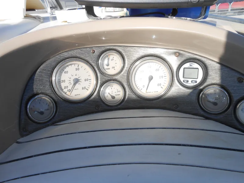 Slide: The Image of Dashboard of a 2003 Glastron GS249 boat with various gauges and instruments. - 7