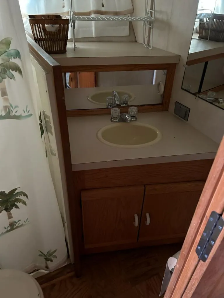 Slide: The Image of 1990 Silverton AFT CABIN bathroom with sink and storage. - 13