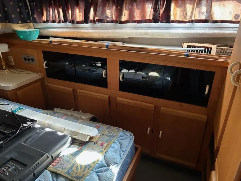 Slide: The Image of Interior of 1990 Silverton AFT CABIN with wooden cabinets and bed. - 22