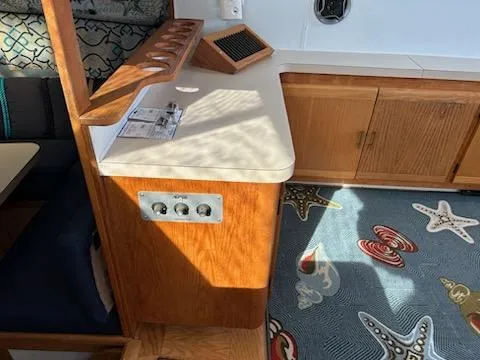 Slide: The Image of 1990 Silverton AFT CABIN interior with wooden cabinetry and starfish-themed carpet. - 6