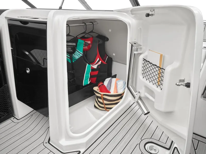 Slide: The Image of 2024 Yamaha Boats 252S interior storage with life vests and beach bag. - 4