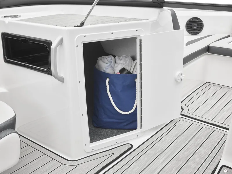 Slide: The Image of Storage compartment on 2024 Yamaha Boats 195S with a blue bag inside. - 5