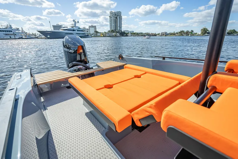 Slide: The Image of 2024 Goldfish 28 Tender boat with orange seating on a sunny day. - 13