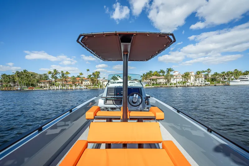 Slide: The Image of 2024 Goldfish 28 Tender boat with orange seating on a sunny day. - 15