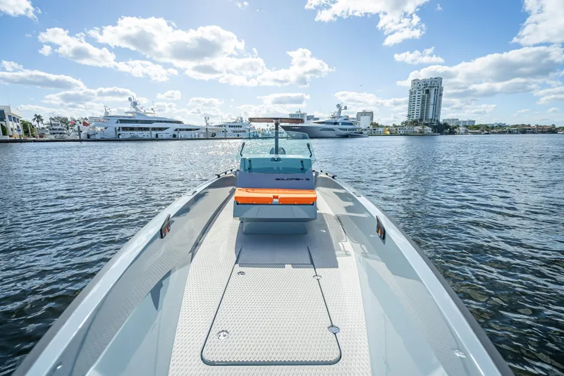 Slide: The Image of 2024 Goldfish 28 Tender boat on water with cityscape background. - 27