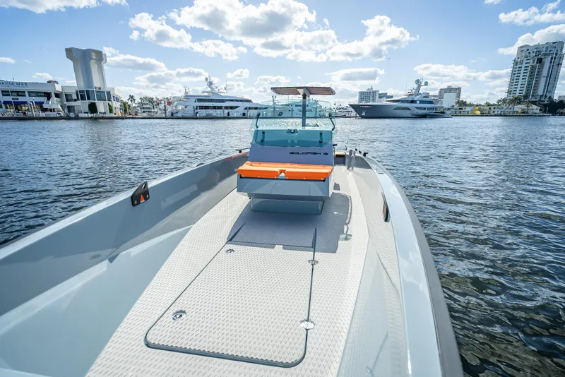 Slide: The Image of 2024 Goldfish 28 Tender boat on water with cityscape background. - 28