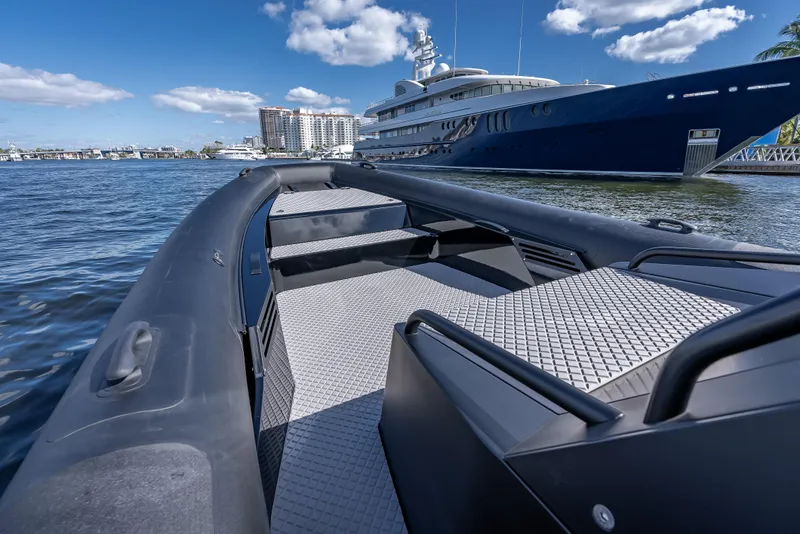 Slide: The Image of 2024 Goldfish X10 Scout boat on water with luxury yacht in background. - 10