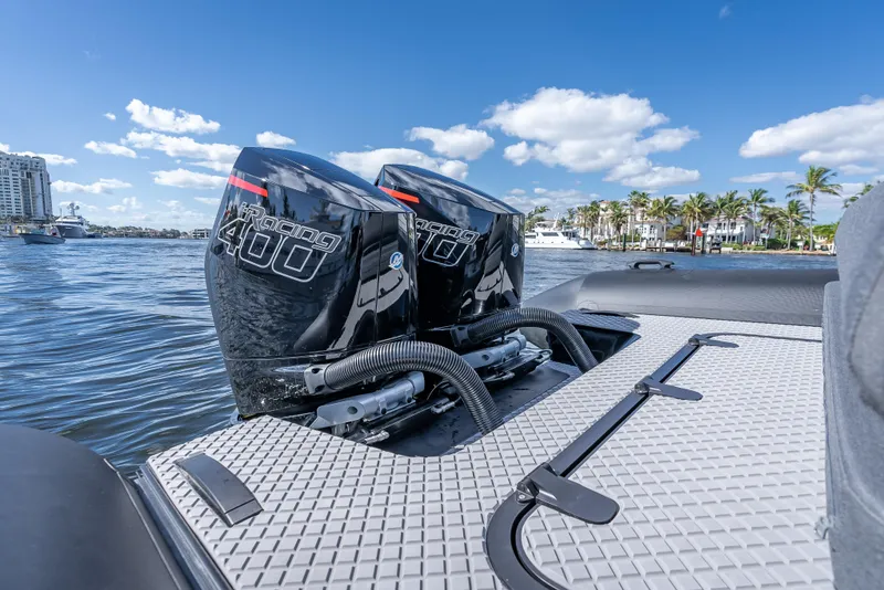 Slide: The Image of Twin outboard engines on a 2024 Goldfish X10 Scout boat, docked by a marina. - 6