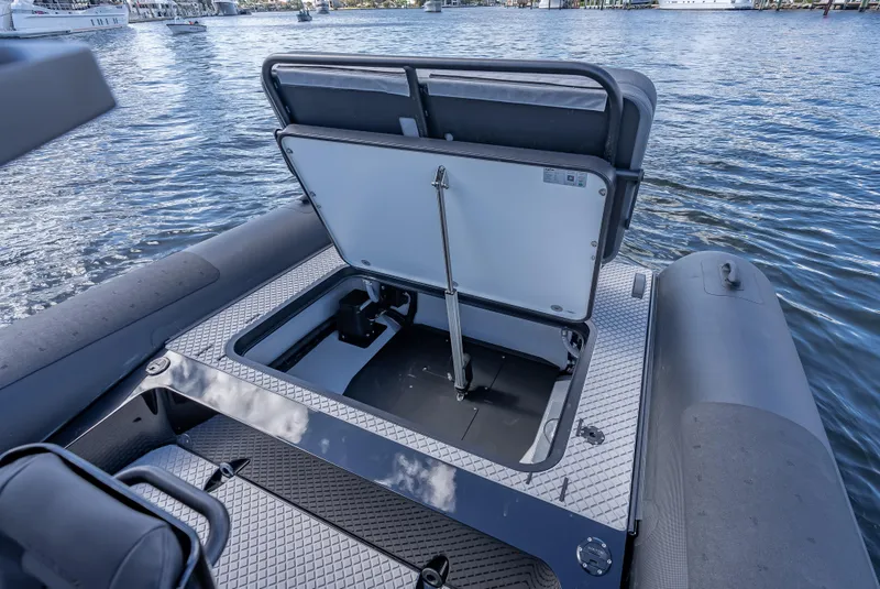 Slide: The Image of 2024 Goldfish X10 Scout boat with open storage compartment on the water. - 8