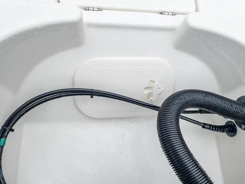 Slide: The Image of Close-up of 2024 Pathfinder 2300 HPS boat's interior wiring and compartment. - 16