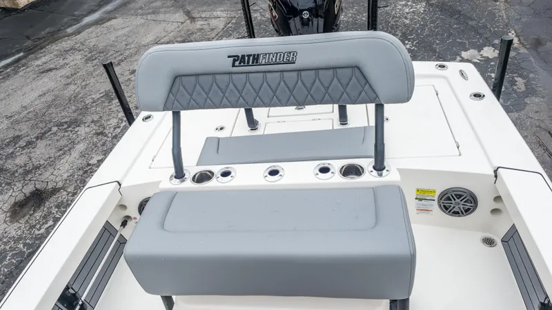 Slide: The Image of 2024 Pathfinder 2300 HPS boat interior with gray seating and rod holders. - 18