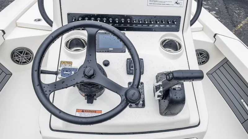 Slide: The Image of 2024 Pathfinder 2300 HPS boat console with steering wheel and controls. - 26