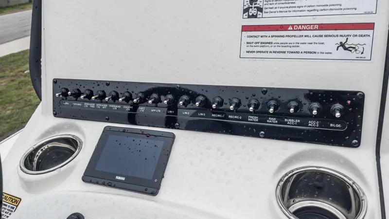 Slide: The Image of 2024 Pathfinder 2300 HPS boat control panel with switches and Yamaha display. - 27