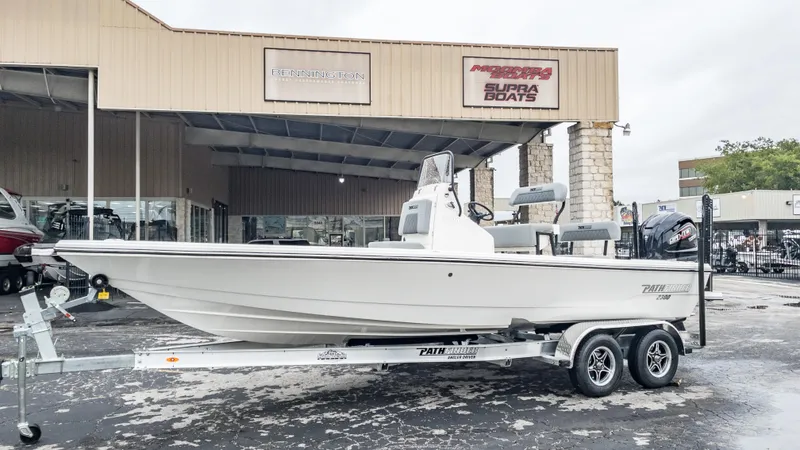 Slide: The Image of 2024 Pathfinder 2300 HPS boat on trailer outside dealership. - 31