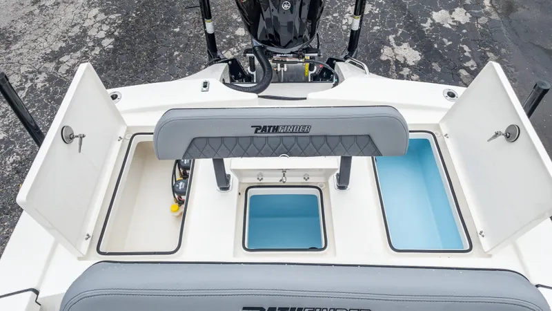 Slide: The Image of 2024 Pathfinder 2300 HPS boat with open storage compartments and seating. - 36