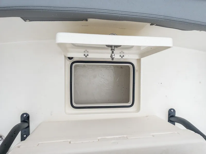 Slide: The Image of Open storage compartment on 2024 Pathfinder 2300 HPS boat. - 38