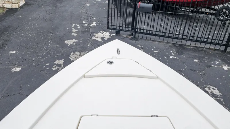 Slide: The Image of 2024 Pathfinder 2300 HPS boat bow on cracked asphalt driveway. - 5