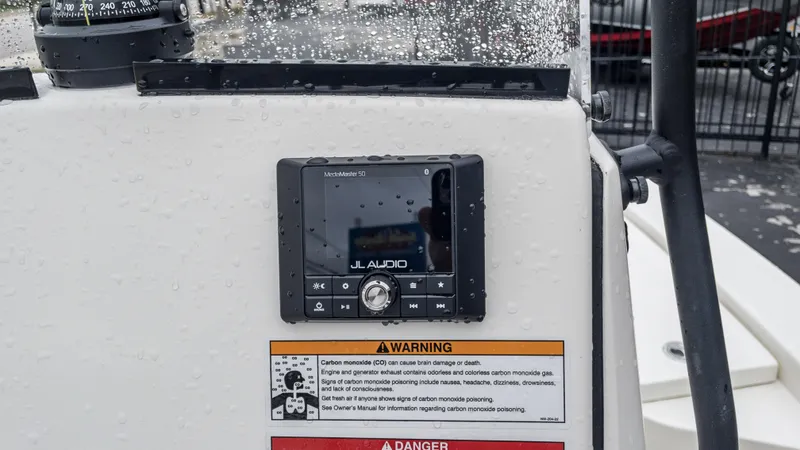 Slide: The Image of JL Audio MediaMaster 50 on 2024 Pathfinder 2300 HPS boat console with warning labels. - 7