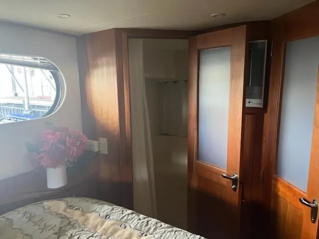 Slide: The Image of Interior of 2002 Silverton 39 Motor Yacht bedroom with ensuite bathroom. - 15