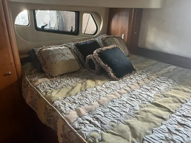 Slide: The Image of Luxurious bedroom in a 2002 Silverton 39 Motor Yacht with elegant bedding and decorative pillows. - 16