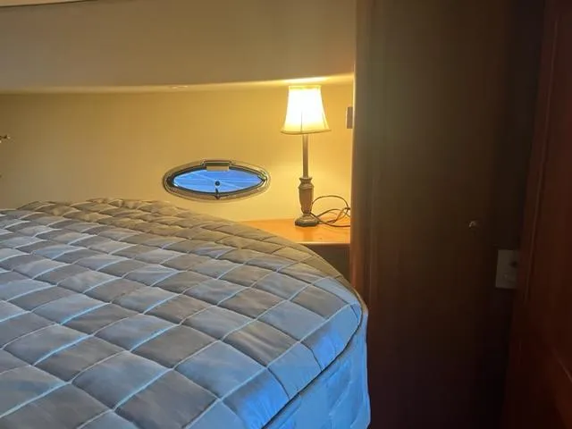 Slide: The Image of Interior cabin of 2002 Silverton 39 Motor Yacht with bed and lamp. - 18