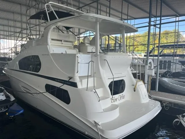 Slide: The Image of 2002 Silverton 39 Motor Yacht docked in a marina. - 2