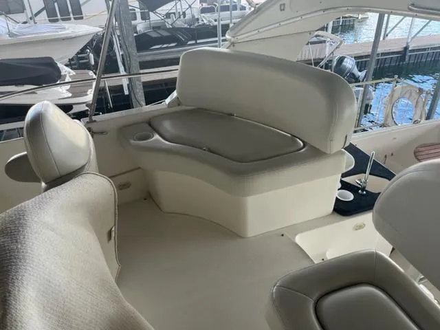 Slide: The Image of 2002 Silverton 39 Motor Yacht interior seating area with white leather upholstery. - 22