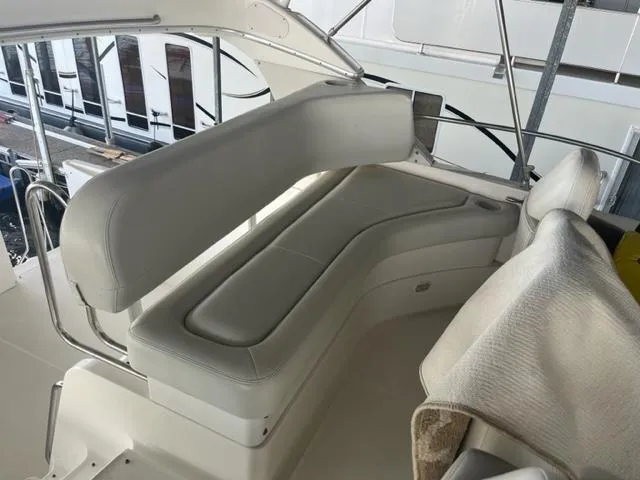 Slide: The Image of 2002 Silverton 39 Motor Yacht interior seating area with white leather upholstery. - 23