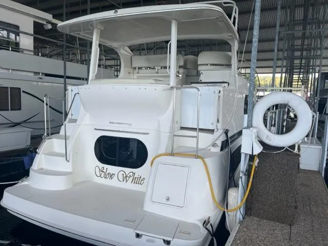 Slide: The Image of 2002 Silverton 39 Motor Yacht docked in a marina, named Slow White. - 3