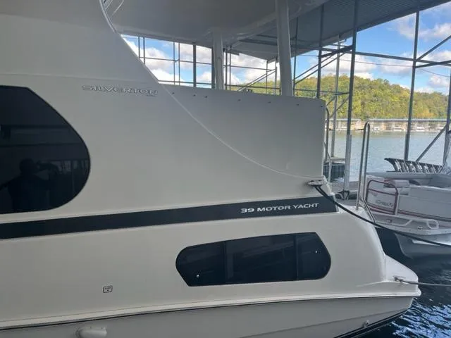 Slide: The Image of 2002 Silverton 39 Motor Yacht docked at a marina. - 4