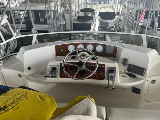 Slide: The Image of Helm of a 2002 Silverton 39 Motor Yacht with steering wheel and control panel. - 5