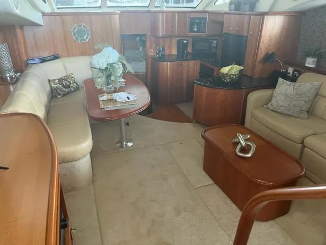 Slide: The Image of Interior of 2002 Silverton 39 Motor Yacht with elegant wood finishes and cozy seating. - 7