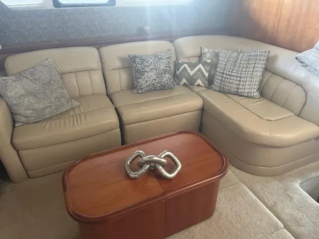 Slide: The Image of Luxurious interior of 2002 Silverton 39 Motor Yacht with beige leather seating and decorative pillows. - 8