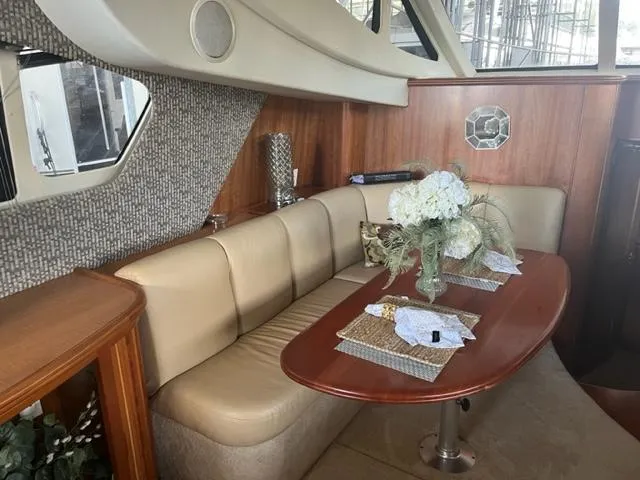 Slide: The Image of Interior of 2002 Silverton 39 Motor Yacht with dining area and floral centerpiece. - 9